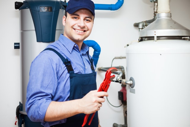 Tomball Water Heater Repair - plumbing technician repairing a water heater.